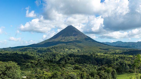 The cone of Arenal Volcano rising above rainforest in Costa Rica
