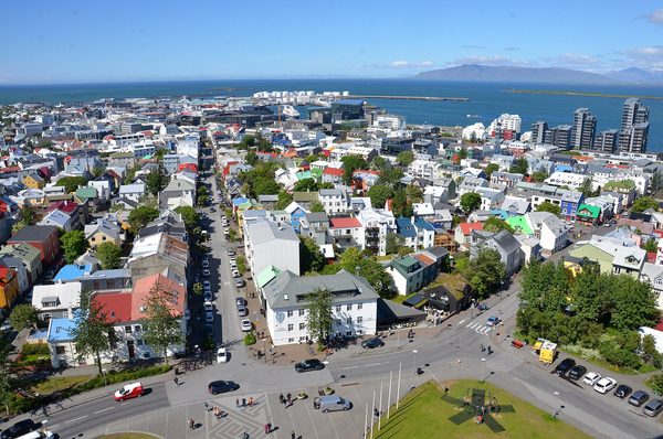 Colorful rooftops of central Reykjavík seen from Hallgrímskirkja, with Faxaflói bay beyond